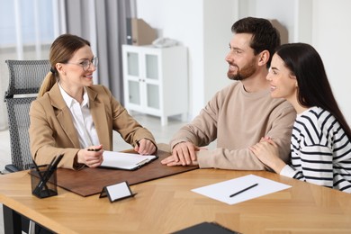 Photo of Couple having meeting with lawyer in office