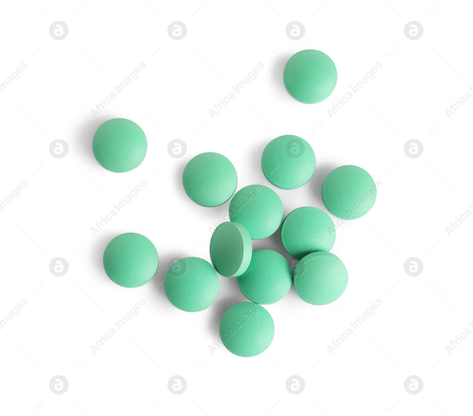Photo of Many light green pills isolated on white, top view