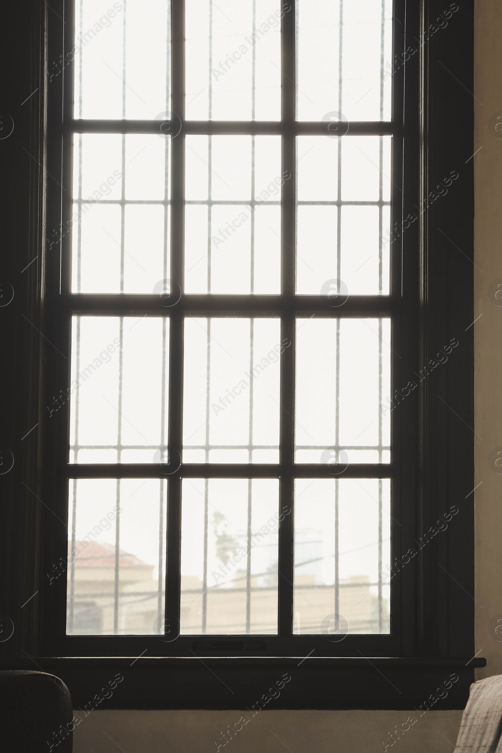 Photo of Window with grid on white wall indoors