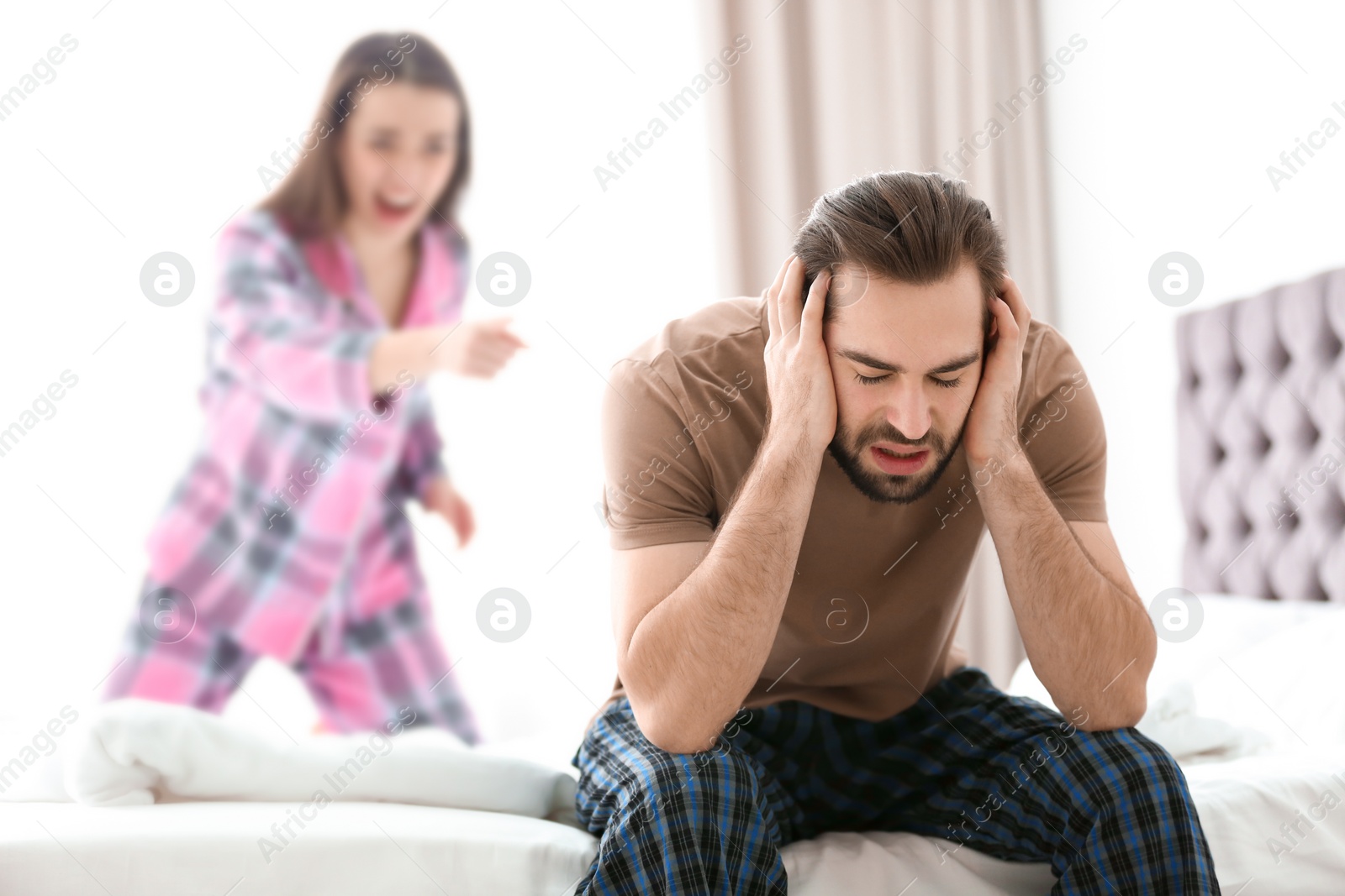 Photo of Young couple having argument in bedroom