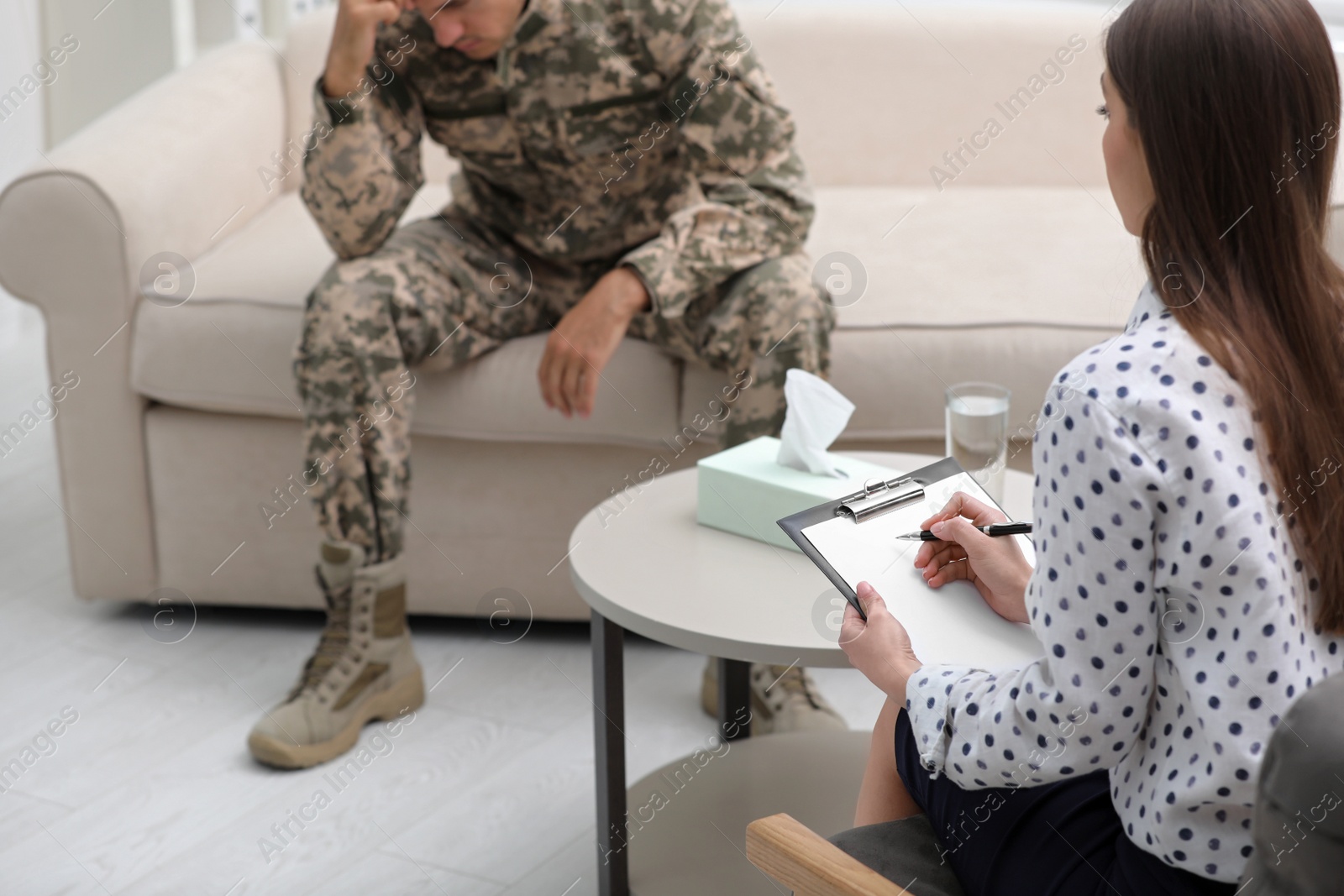 Photo of Psychotherapist working with male military officer in office