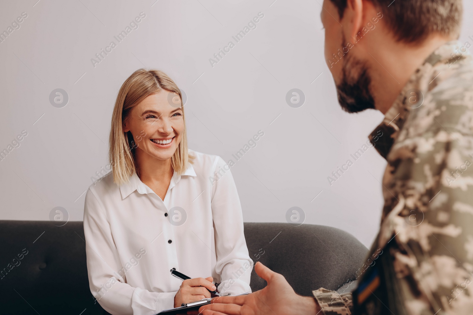 Photo of Psychologist working with military officer in office