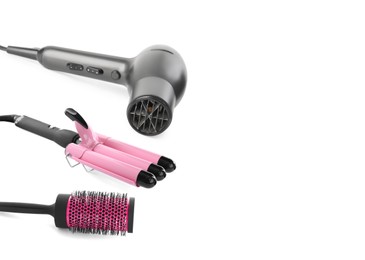 Image of Hair dryer, round brush and triple curling iron on white background