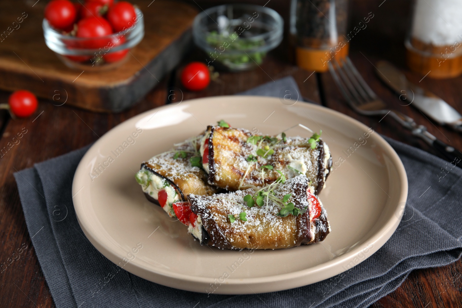 Photo of Delicious baked eggplant rolls served on wooden table