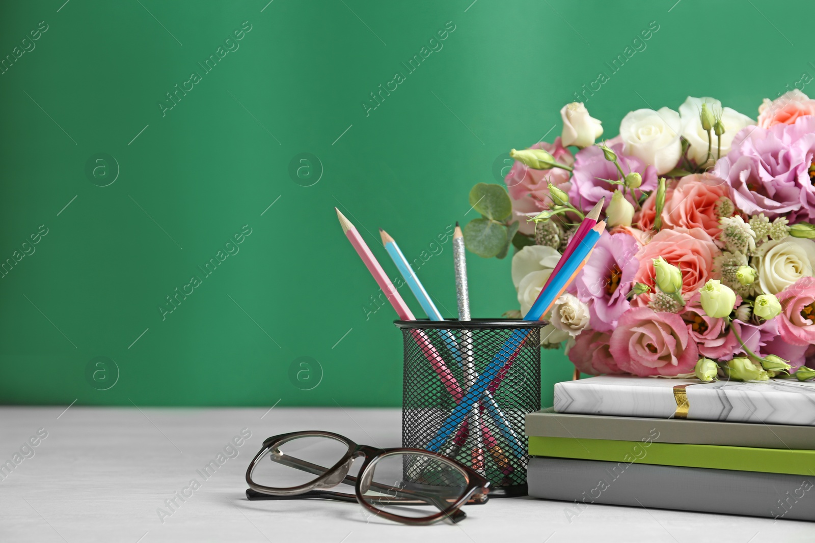 Photo of Composition with flowers and glasses for Teacher's day on white table