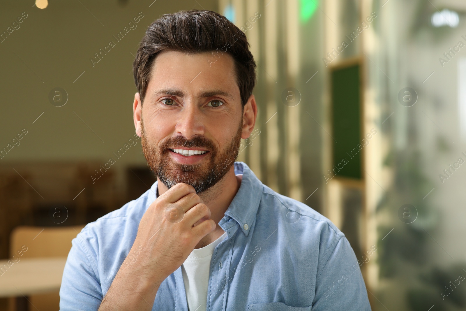 Photo of Portrait of handsome stylish man in cafe