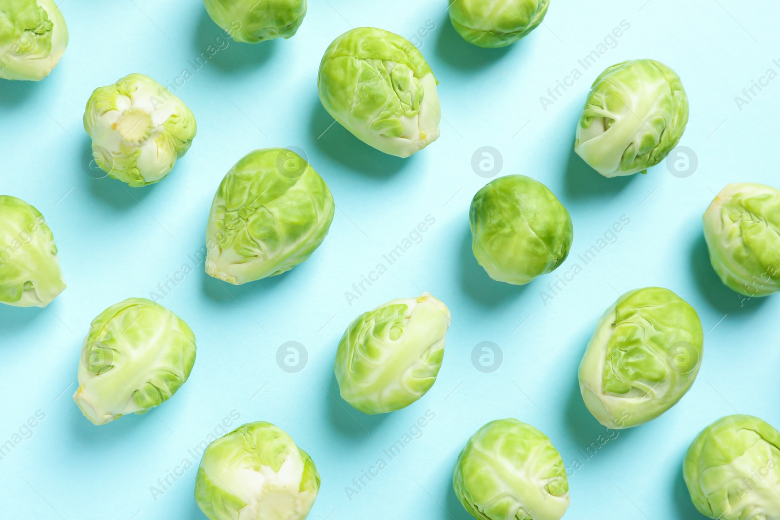 Photo of Fresh Brussels sprouts on color background, flat lay