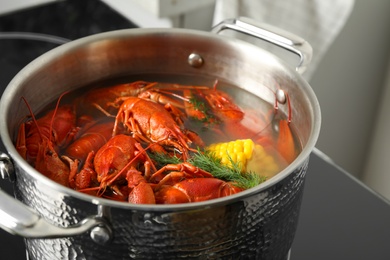 Fresh delicious crayfishes in pot on stove, closeup