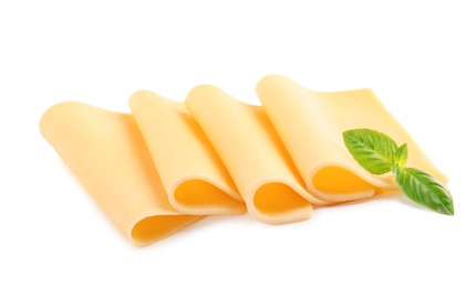 Photo of Slices of tasty cheese with basil on white background