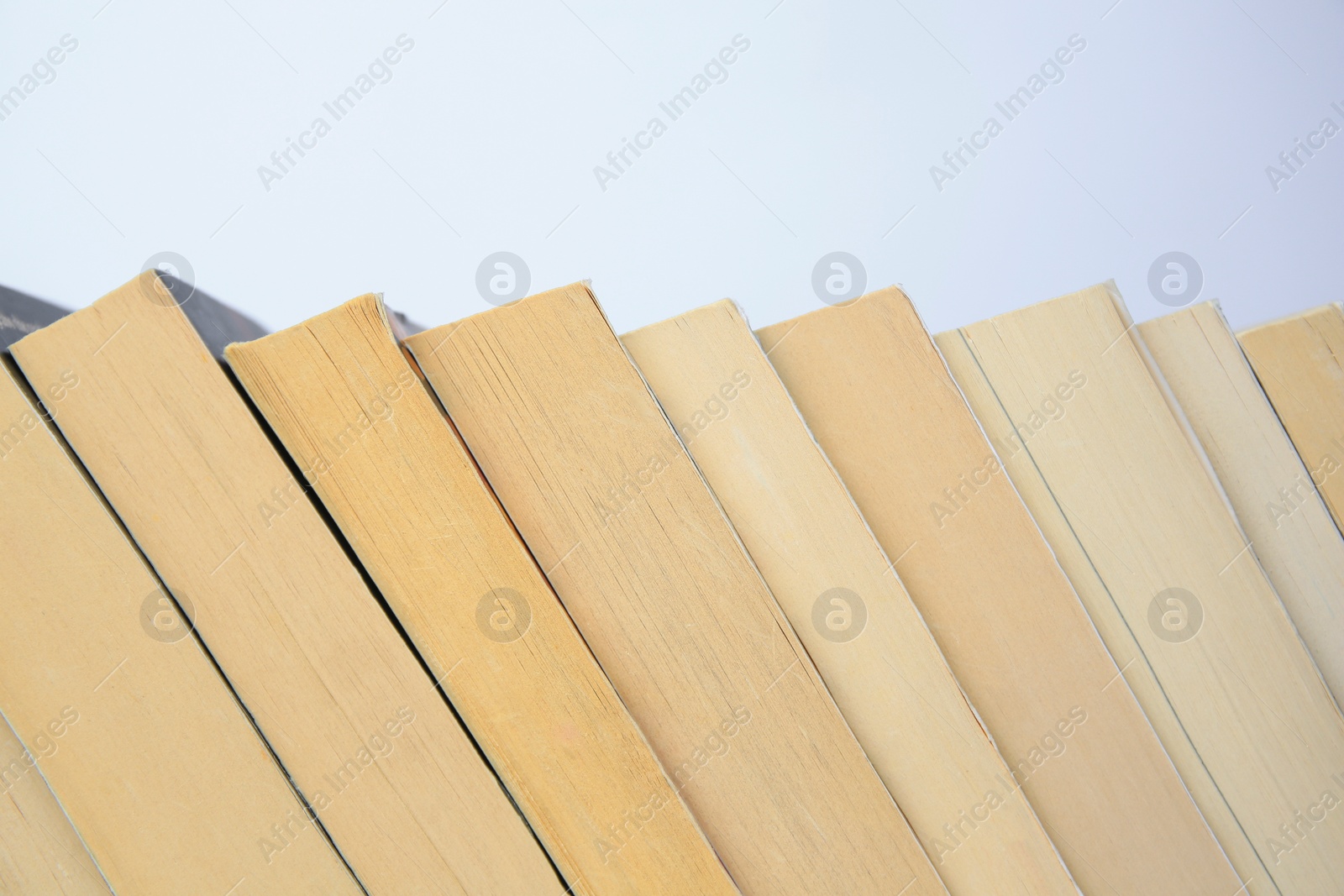 Photo of Collection of different books on light background