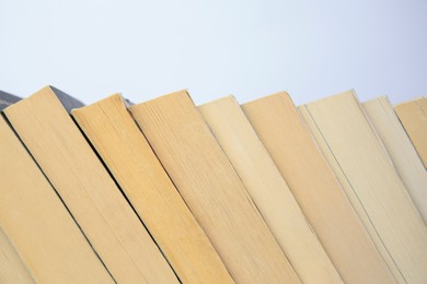 Photo of Collection of different books on light background