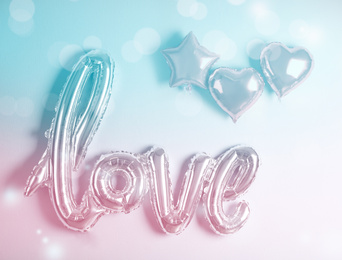 Image of LOVE word and heart balloons on color background. Valentine's day