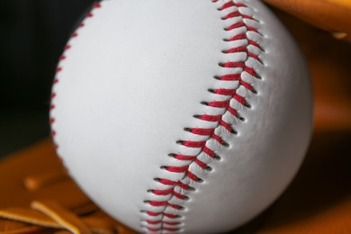 Photo of Leather baseball glove with ball, closeup view