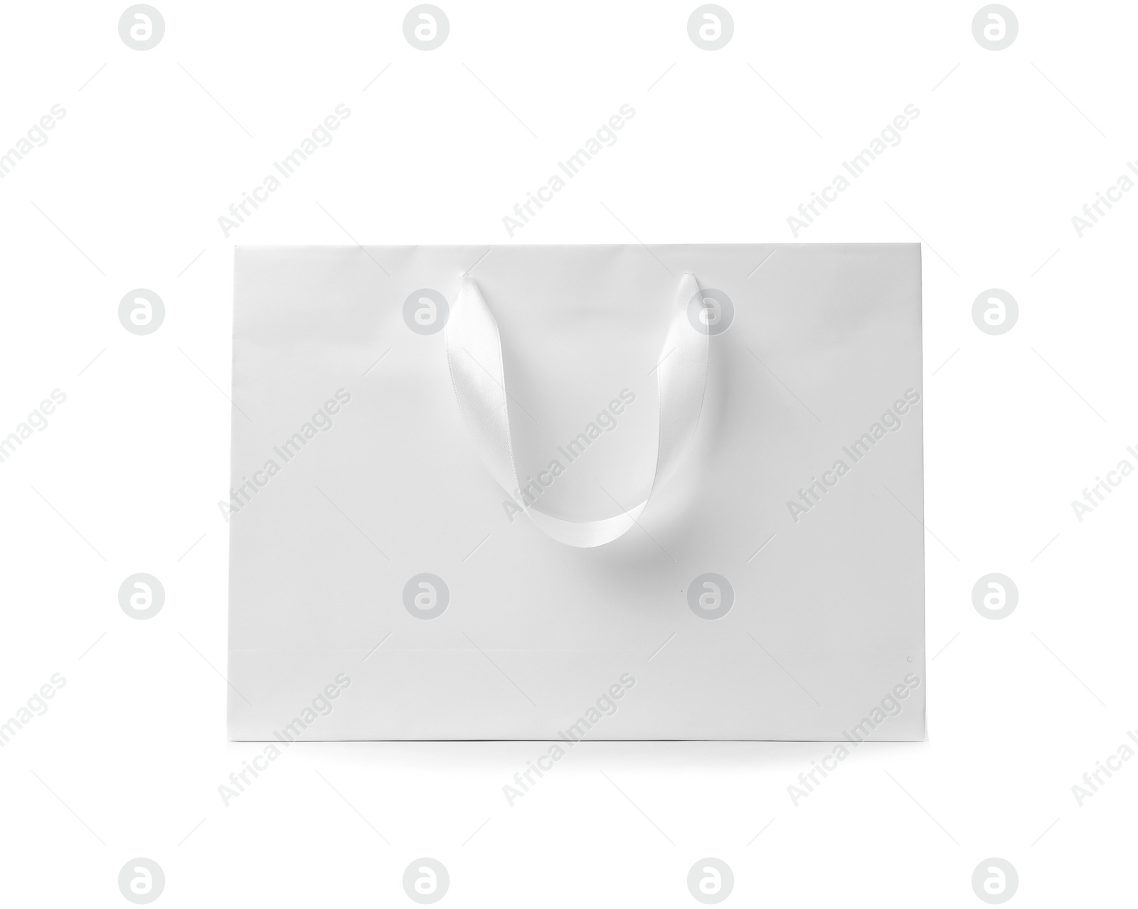 Photo of Paper shopping bag with ribbon handles on white background. Mockup for design