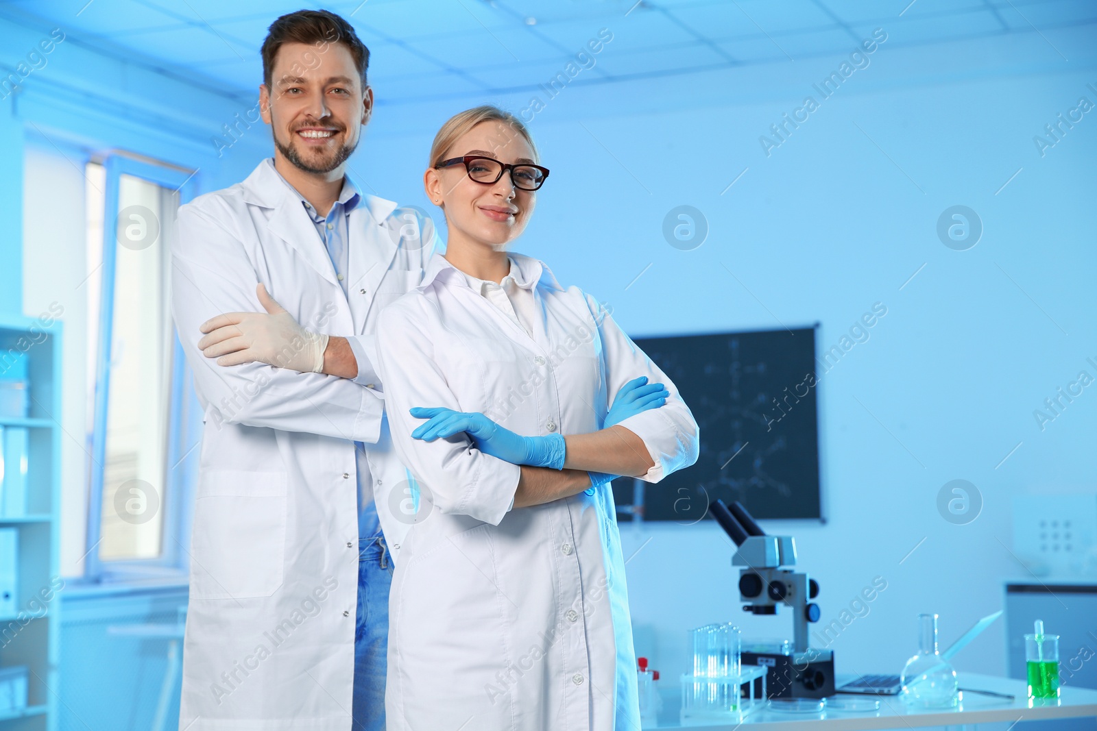 Photo of Portrait of scientists in chemistry laboratory, space for text