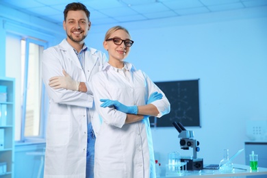 Portrait of scientists in chemistry laboratory, space for text