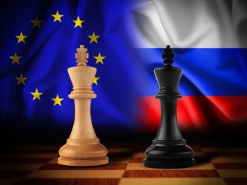 Image of Kings on chessboard with European union and Russian flags on background. Political feud