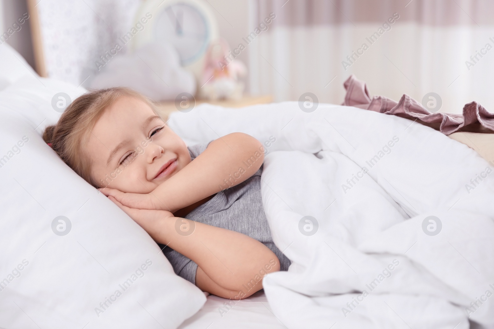 Photo of Cute little girl sleeping in bed at home