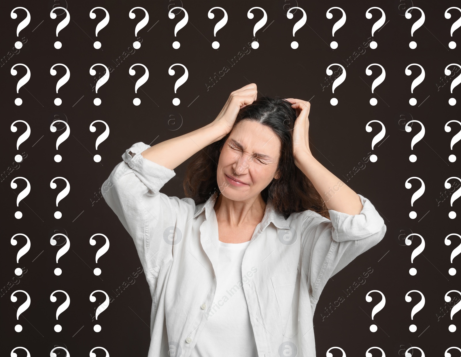 Image of Amnesia. Confused woman and question marks on brown background