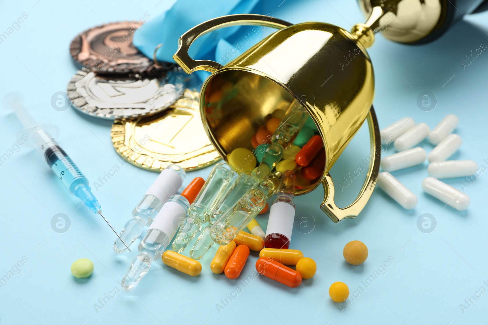 Photo of Composition with drugs on light blue table, closeup. Doping control