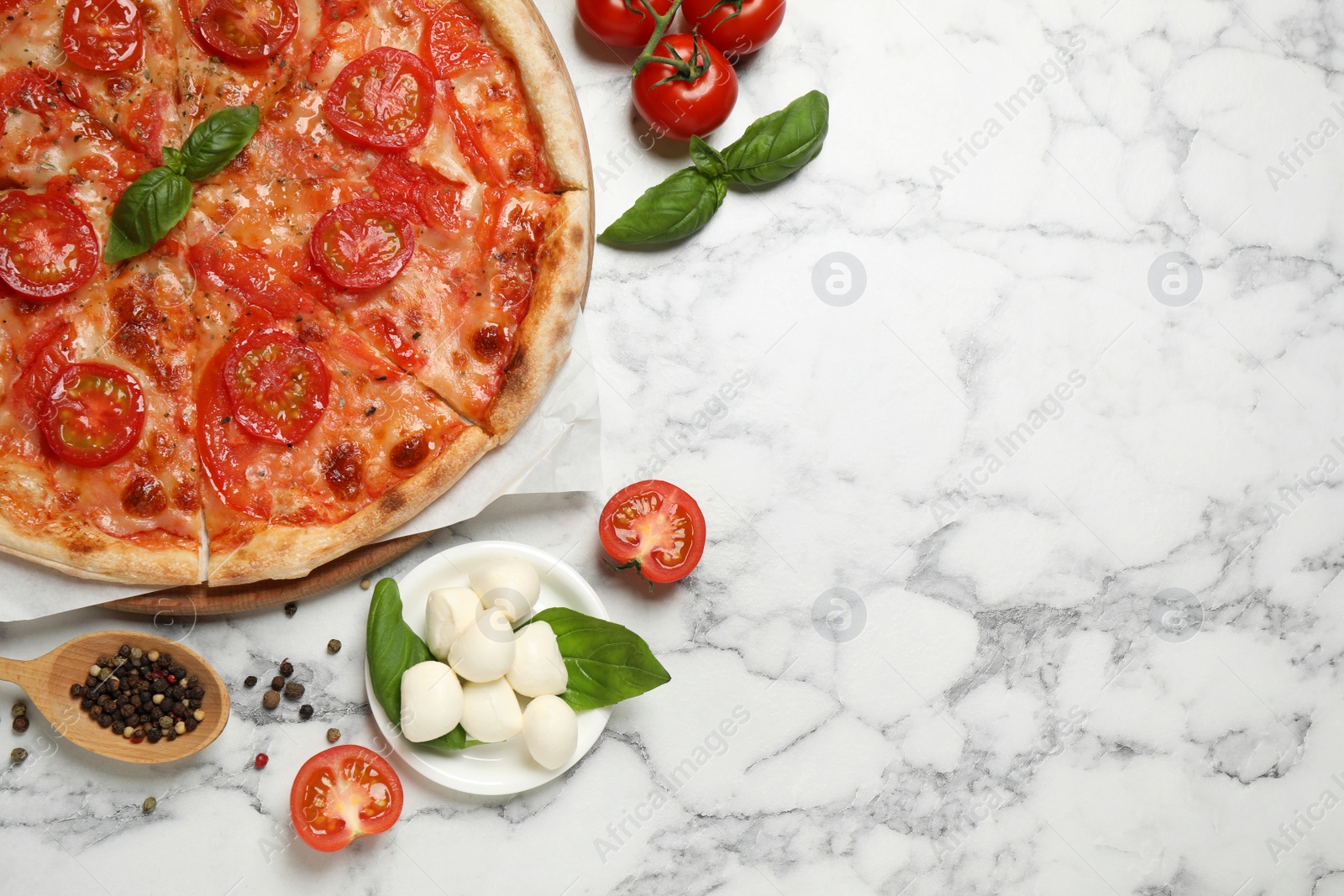 Photo of Delicious pizza Margherita and ingredients on white marble table, flat lay. Space for text