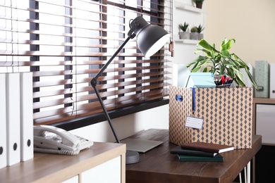 Photo of Moving box on desk in office. Work promotion concept