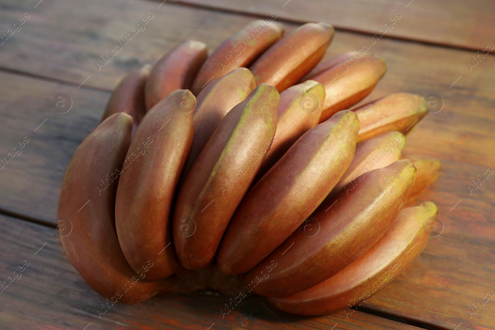 Photo of Tasty purple bananas on wooden table, closeup