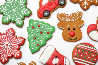 Photo of Different tasty Christmas cookies on white background, flat lay