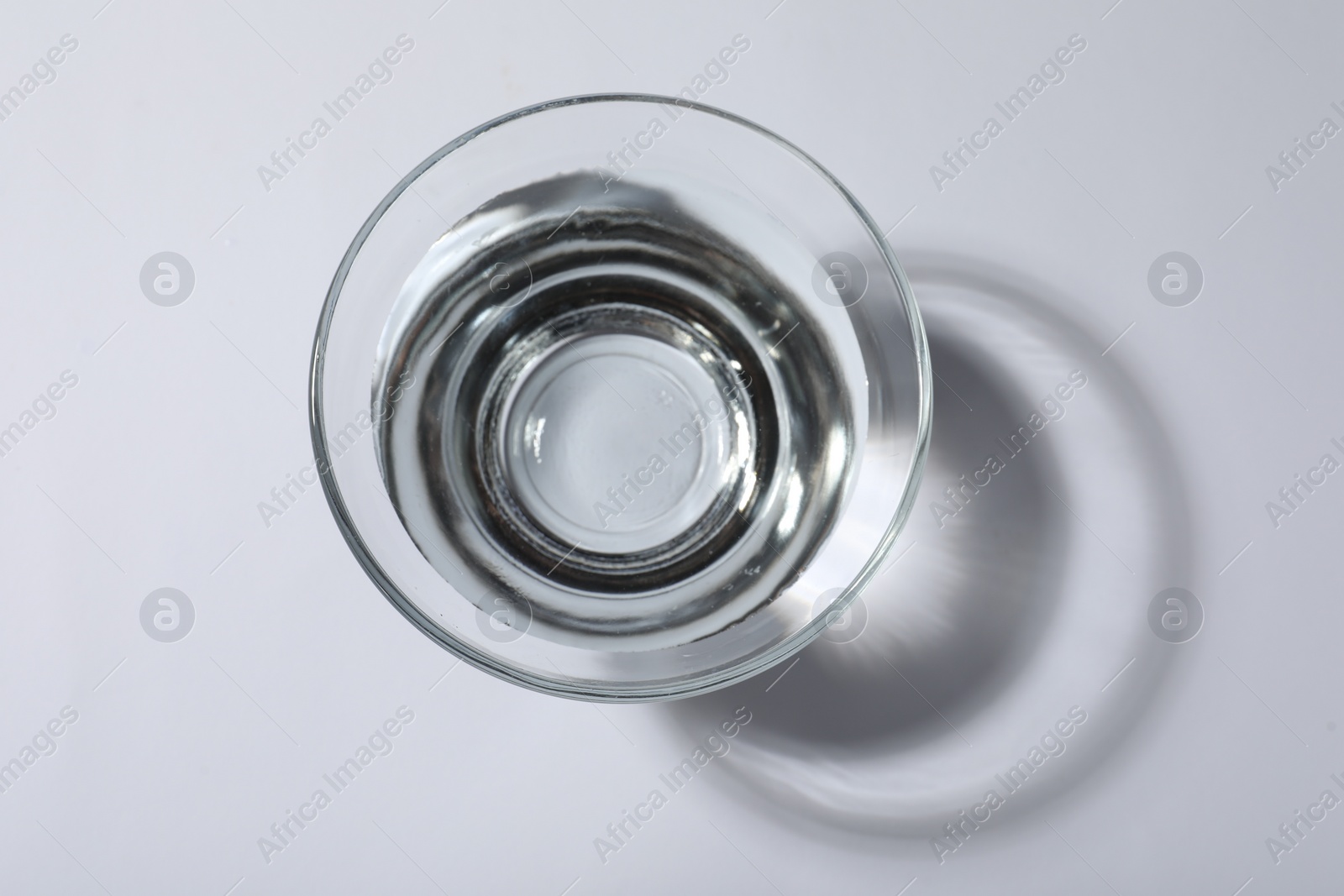 Photo of Glass bowl with water on white background, top view