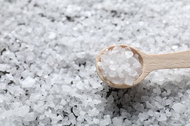 Photo of Natural salt and wooden spoon, closeup view