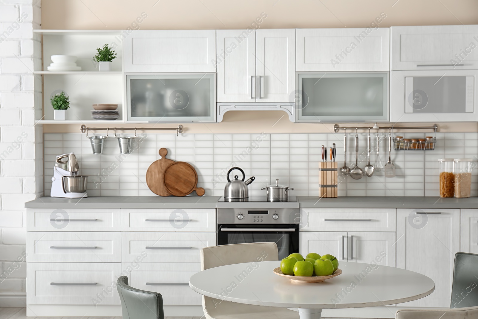 Photo of Stylish kitchen interior with dining table and chairs