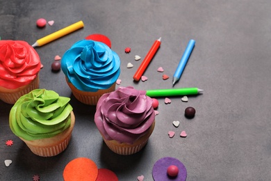 Photo of Delicious birthday cupcakes on gray background