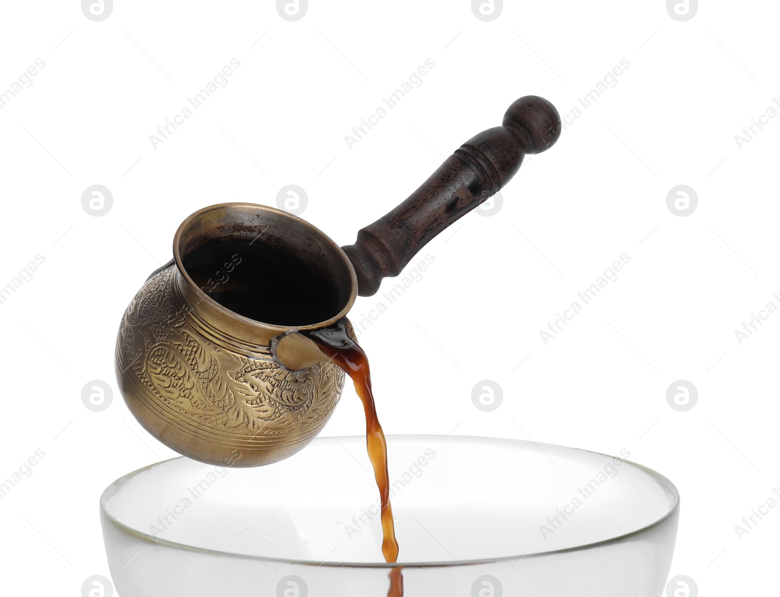 Photo of Turkish coffee. Pouring brewed beverage from cezve on white background