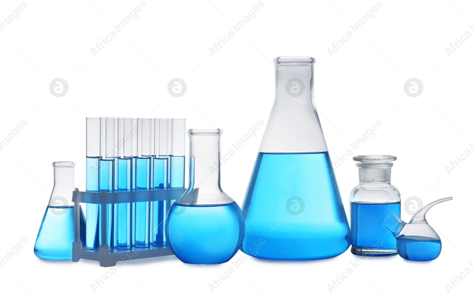 Photo of Set of laboratory glassware with blue liquid on white background