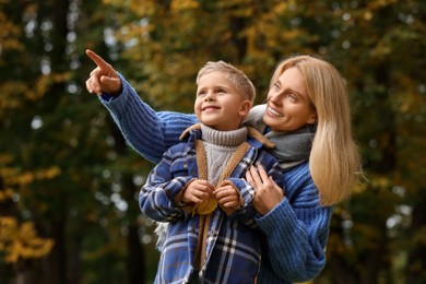 Photo of Happy mother with her son in autumn park