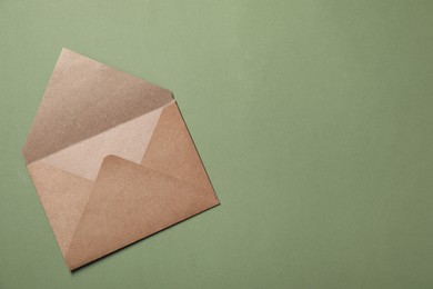 Letter envelope on green background, top view. Space for text