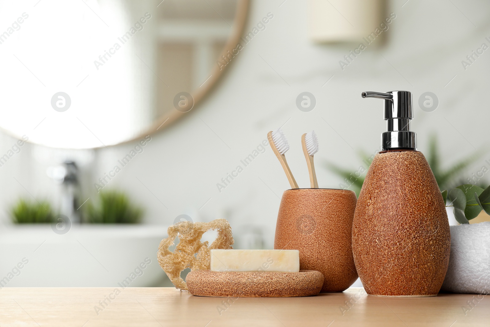 Image of Bath accessories. Different personal care products and eucalyptus leaves on wooden table in bathroom, space for text