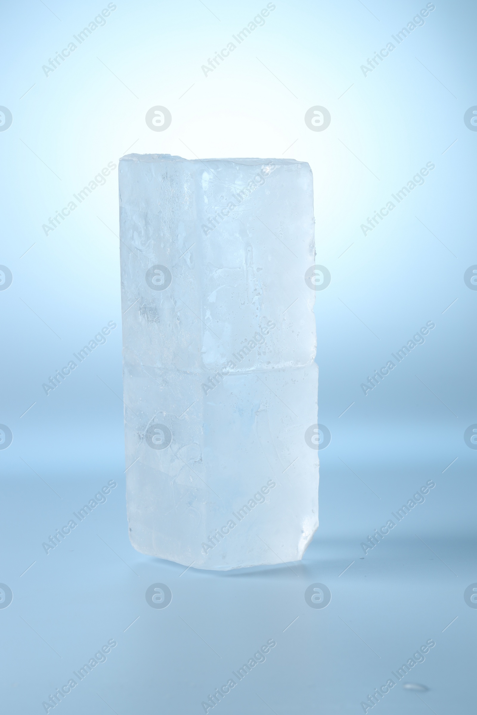Photo of Blocks of clear ice on light blue background