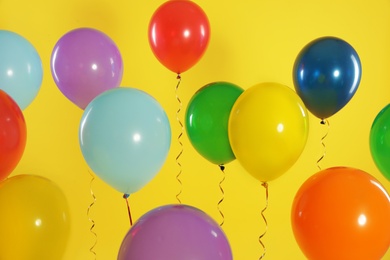 Photo of Bright balloons on color background. Celebration time