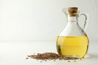 Caraway (Persian cumin) seeds and fresh oil on white table, space for text