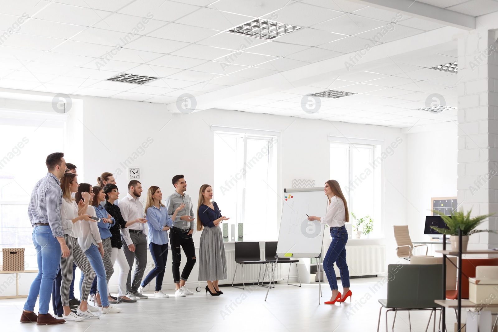 Photo of Female business trainer giving lecture in office