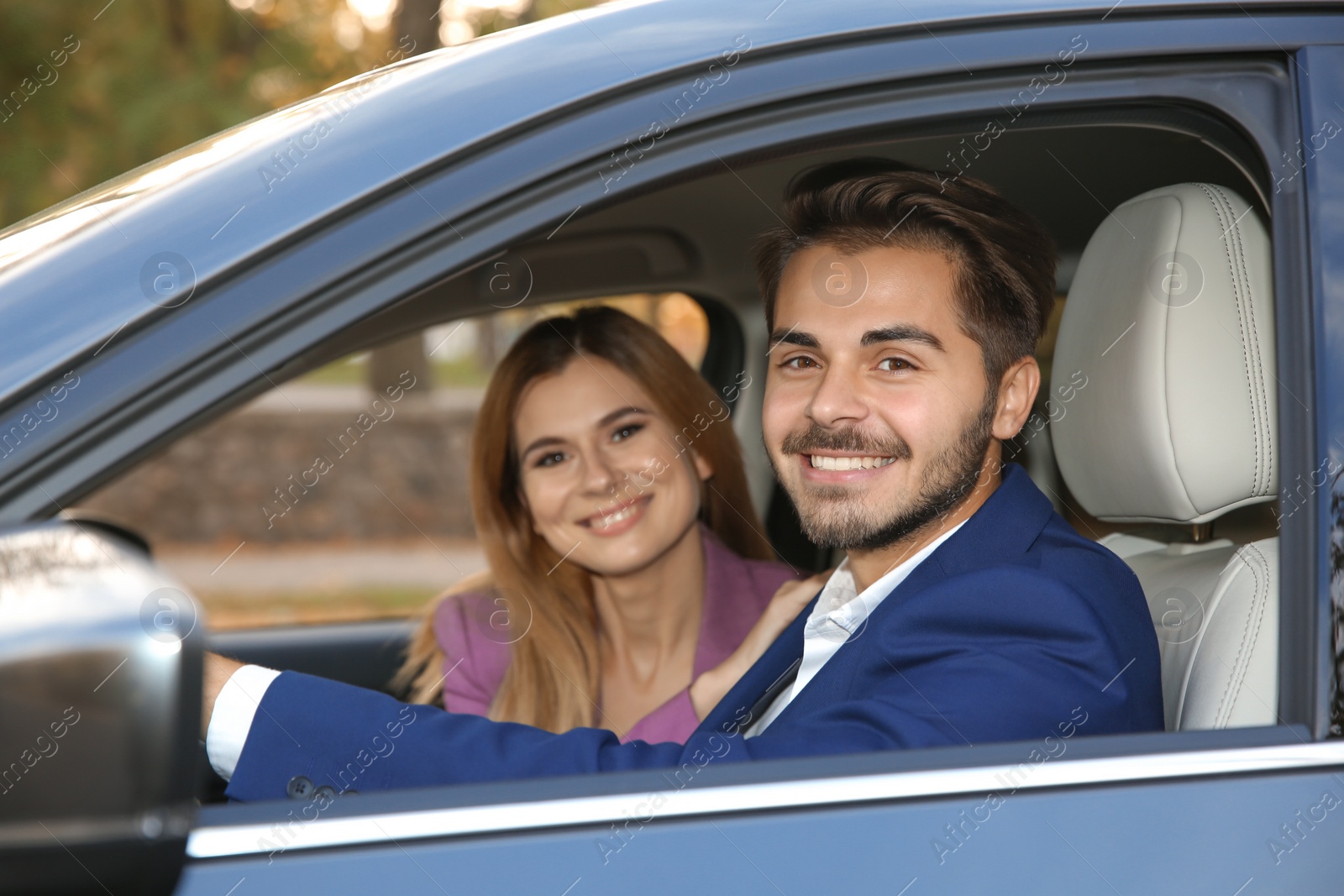 Photo of Young man sitting in car with passenger. Driving license test