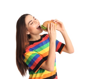 Photo of Young woman eating tasty burger on white background