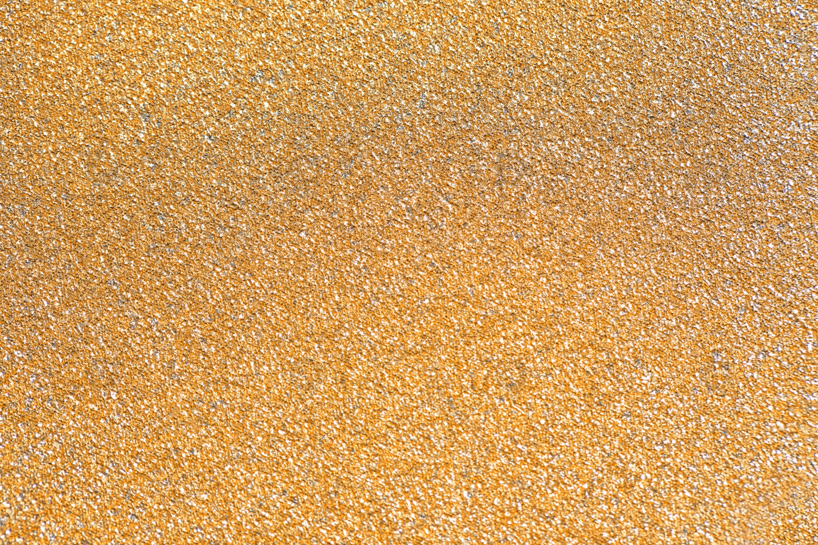 Photo of Beautiful golden shiny glitter as background, top view