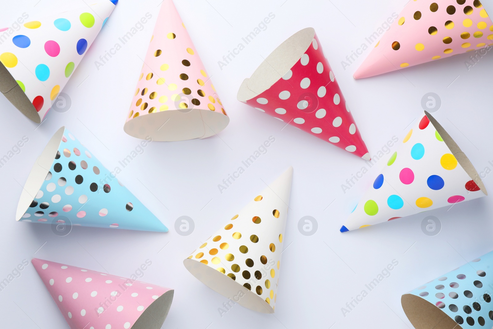 Photo of Colorful party hats on light background, top view