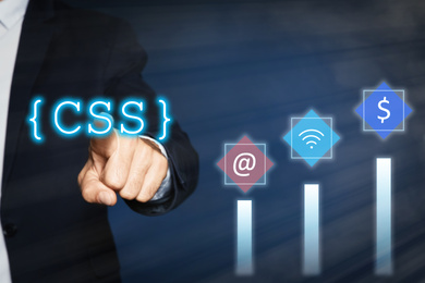 Image of Web development. Man using button CSS on virtual screen, closeup 