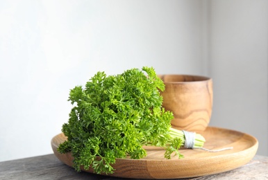 Dishware and fresh green parsley on table