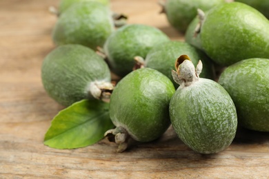 Fresh green feijoa fruits on wooden table, closeup