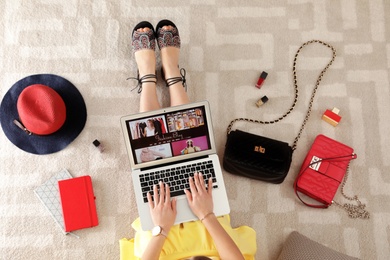 Photo of Woman and laptop with fashion blogger site on floor, top view