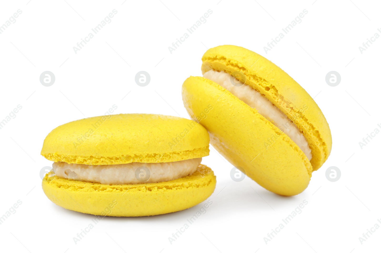 Photo of Yellow macarons on white background. Delicious dessert